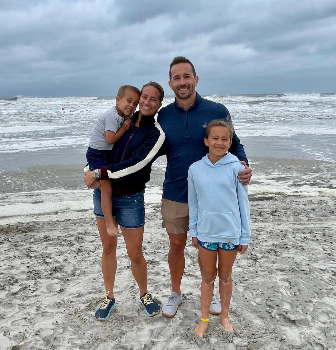 My Family picture, with the four of us posing on a beach with ocean waves in the background
